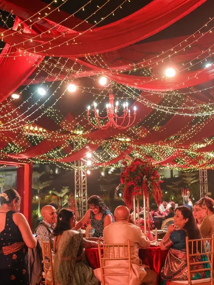 A grand reception under a canopy of red drapes and fairy lights. This setting for Sonam and Ross at Amitarasa was designed to feel both grand and intimate, a perfect space for conversations and making memories.