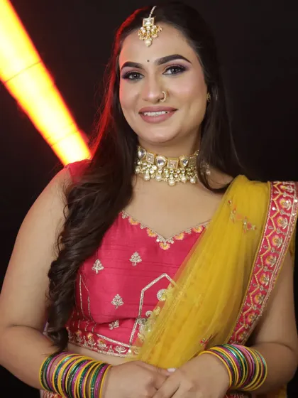 A beautiful portrait showcasing the detailed makeup and the maang tikka that completes the festive look.