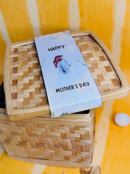 A close up of our charming bamboo box for a Mother's Day gift, sealed with a custom "Happy Mother's Day" band.