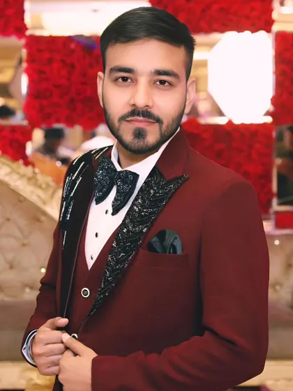A portrait of the groom looking sharp in his tuxedo during an engagement event in Noida.