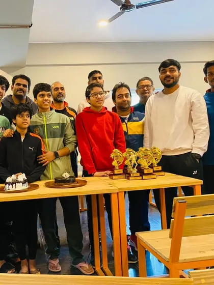 A wider shot of the team celebrating with trophies and cakes. These are the best moments for the AKS family.