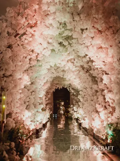Guests entered the engagement party through a breathtaking tunnel of white blossoms. This immersive entrance created a magical transition into the main event space.
