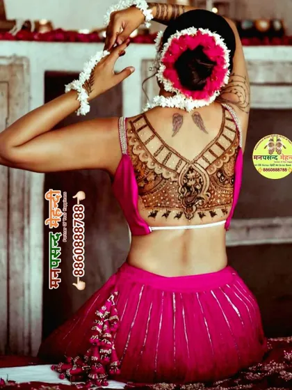 A unique and stylish back mehndi design featuring Lord Ganesha. This type of henna tattoo is a modern way to wear traditional symbols for special occasions.