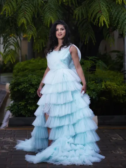 A front-facing portrait that shows how the soft makeup look enhances the model's natural beauty without overpowering the elaborate gown.