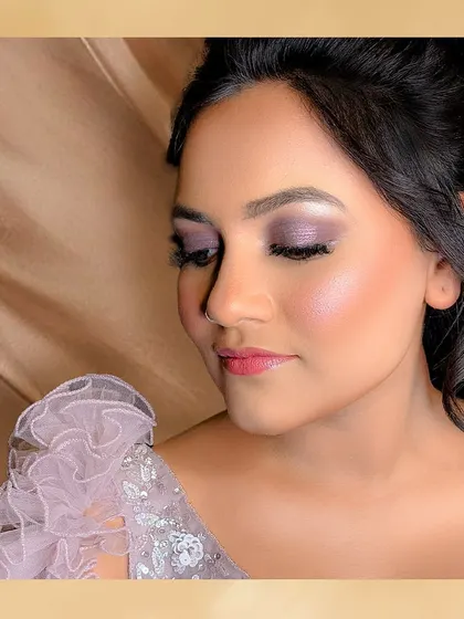 The purple eyeshadow for this reception look was a perfect choice. It complements her lavender gown beautifully and adds a touch of modern glamour.