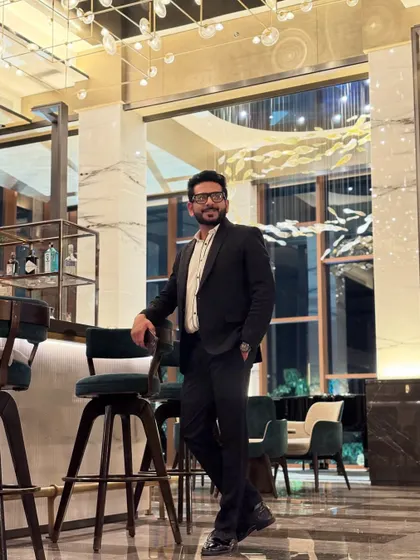 A moment of quiet before the storm of a star-studded wedding event. Dressed in a sharp tux, ready to take the stage and create an evening to remember.