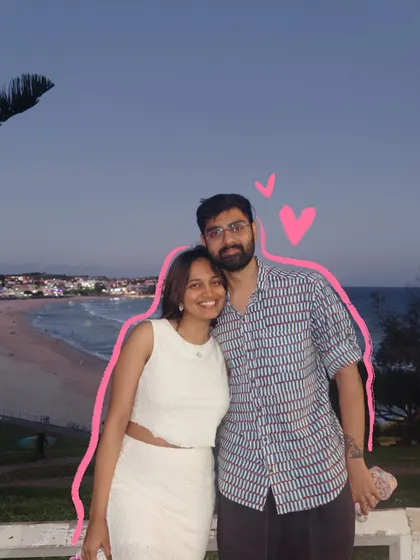 A sweet couple photo at the beach, outlined in pink with some little hearts to make it even cuter.