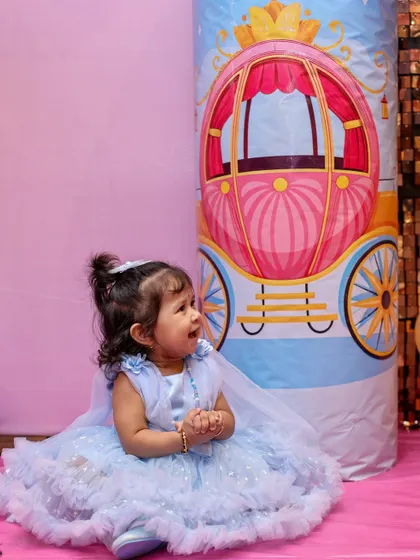A candid shot of the birthday girl, Shrinika, looking adorable in her blue party dress. We always look for those unposed moments that perfectly capture a child's personality.