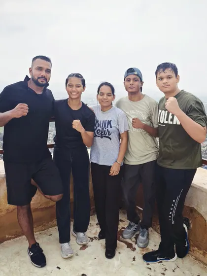 The team posing together. We stand strong together, as fighters and as a family.