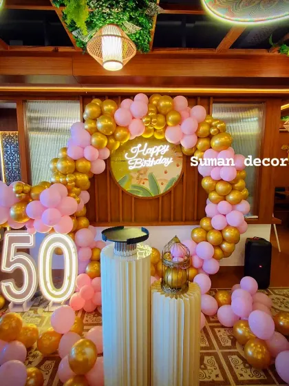 Another view of the 50th birthday setup, highlighting the chrome gold and pink balloons.