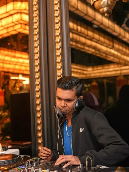Another focused shot of me with headphones on, listening intently to the mix to ensure a seamless transition.