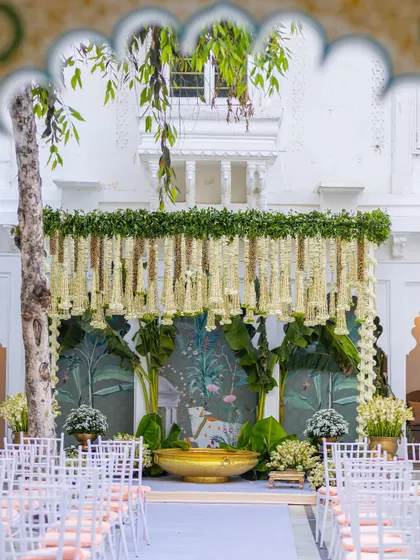 We honor timeless traditions with our classic South Indian wedding decor. This mandap features intricate floral hangings of jasmine and tuberose, framed by fresh banana leaves, creating an authentic and sacred space for the ceremony.