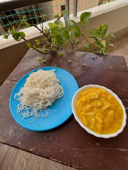 A comforting and traditional combination of Otthu Shavige (freshly pressed rice noodles) and Sheekarne (a sweet mango and coconut milk curry).
