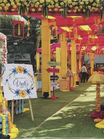 The vibrant entrance to a Haldi ceremony. We used bright yellow and pink structures, traditional genda phool garlands, and a custom welcome sign to build excitement from the moment guests arrived.