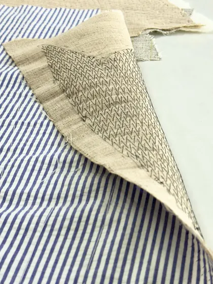 This is a close-up of pad stitching, or Kulti as we call it in India. This meticulous hand-stitching technique attaches the inner hair canvas to the lapel fabric, creating the graceful and firm roll that defines a high-quality jacket.