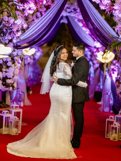 A stunning full-length shot on the red carpet. The bride's elegant gown and classic beauty are truly the center of attention.