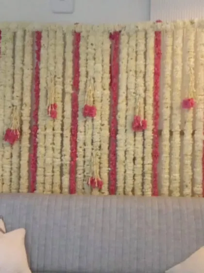 A beautiful floral wall made of white and pink flower strings. This elegant and fragrant backdrop is perfect for a ring ceremony, Mehandi, or even as a photo booth.
