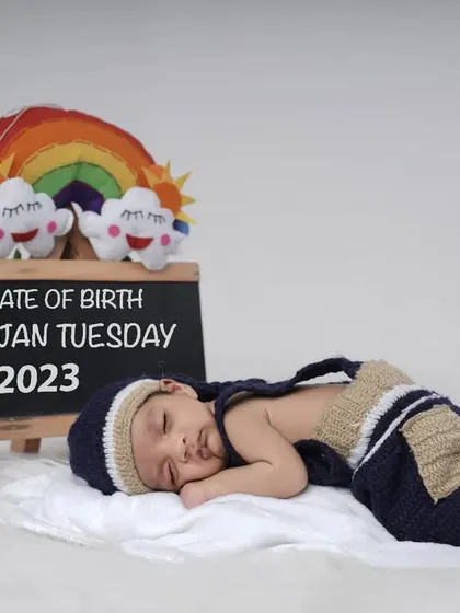 A personalized way to announce your baby's arrival. This setup includes a chalkboard with the baby's birth details, creating a unique and memorable keepsake photo.
