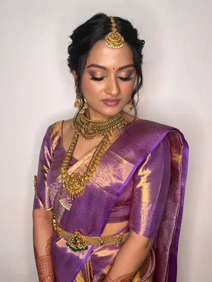A beautiful shot of the bride with her eyes closed, showcasing the golden shimmer eyeshadow. This look is all about intricate details and timeless style.