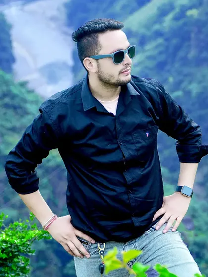 A cool and confident portrait against a backdrop of a valley. This is a great example of an environmental portrait that captures a sense of place.