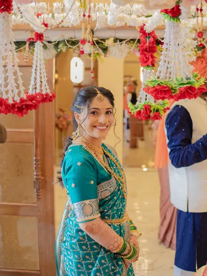 A happy, candid shot of the bride during her wedding ceremony. Her smile shows her joy, and the makeup looks fresh and flawless even in a bustling environment.