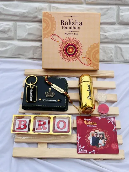 This Rakhi hamper includes a personalized wallet, keychain, and perfume bottle, along with a 'BRO' chocolate box and a custom photo card.