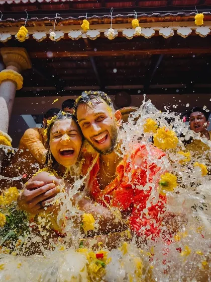 A moment of pure fun as the couple gets drenched during their Haldi. These candid shots capture the true spirit of the celebration.