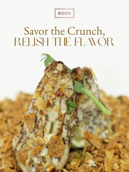 Every bite of this dish is a symphony of crunch and flavour. Here, crispy elements are layered with a creamy sauce and fresh herbs, creating a multi-sensory experience.