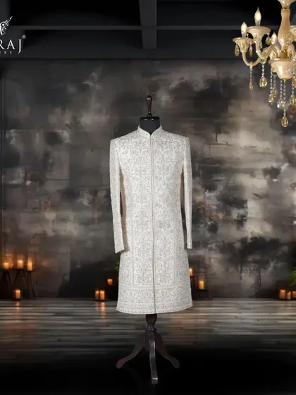 Inspired by Persian heritage, this off-white silk sherwani is a work of art. It features intricate aari and sequin detailing, elevated by a stunning blend of blue and pink Meenakari embroidery for a truly unique groom's outfit.