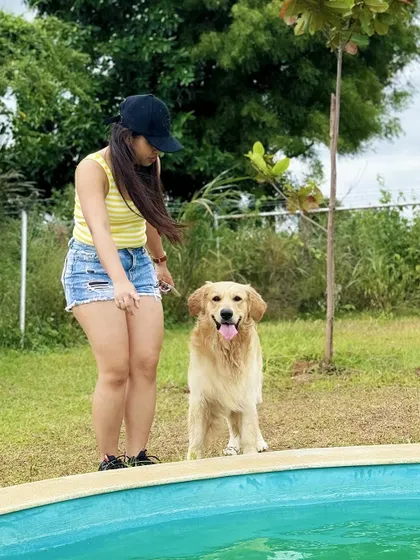 An owner and her Golden Retriever by the pool, enjoying their private time at the camp.
