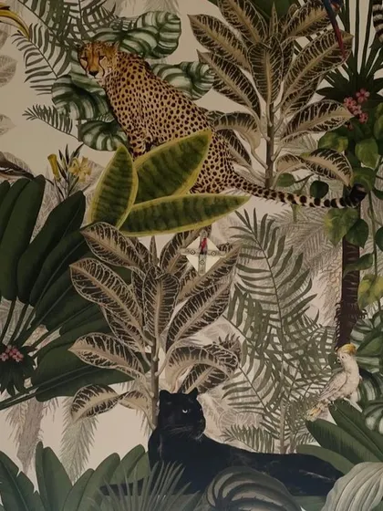We love using bold wallpapers to tell a story. This one, with its lush jungle scene, adds drama and personality to a room.
