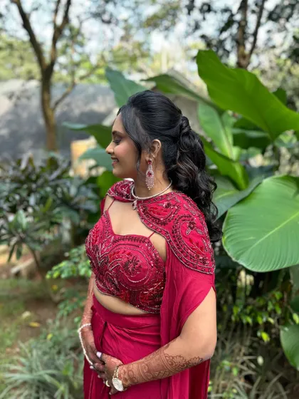 Another angle of this popular hairstyle, showing its versatility and how it complements the modern, caped blouse.