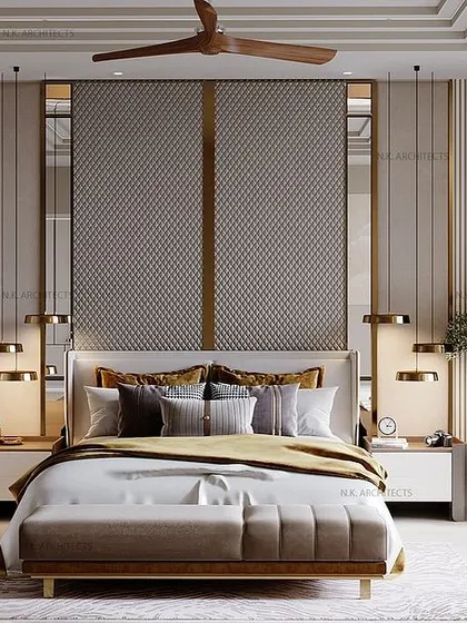 This bedroom is all about creating a sanctuary. We used soothing shades of grey, textured fabrics, and golden inlays for a touch of luxury. The large mirror behind the bed reflects light and adds depth to the space.