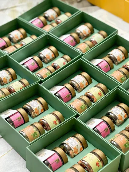 Organization is key when handling bulk orders. Here, our mini jars of nuts and mukhwas are sorted in boxes, ready to be added to our festive hampers.