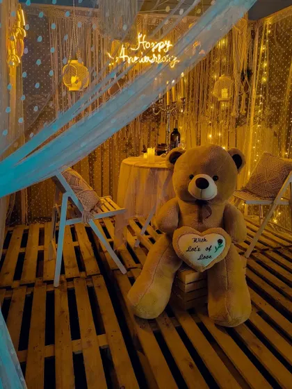 Your home can be the most romantic place on earth. This cozy macrame canopy, filled with warm fairy lights and a custom "Happy Anniversary" neon sign, is perfect for an intimate anniversary surprise or a quiet date night in.