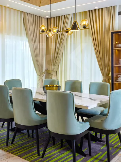 The full view of the elegant dining area, showcasing the modern chandelier and the harmonious color palette.
