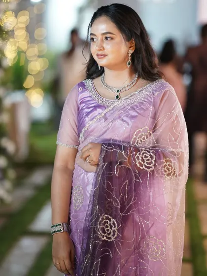 Another angle of the same client, showing how the necklace and matching earrings complete her lavender saree look.