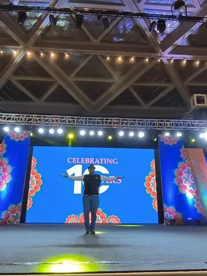 On stage for the 10th-anniversary celebration of Logixhealth. This massive setup includes multiple LED screens, a full lighting truss, and a stage ready for a huge corporate crowd.