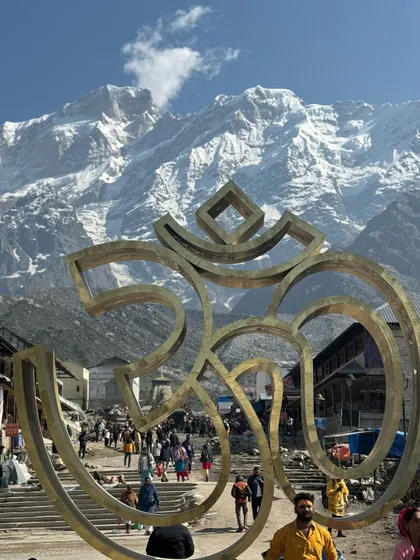 The iconic 'Om' sculpture at Kedarnath, perfectly aligned with the snow-covered Himalayan peaks in the background. A symbol of the cosmic energy that permeates this sacred land.