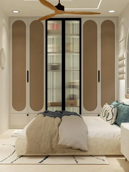 The other side of the minimalist bedroom, showing the clean lines of the wardrobe and simple, circular wall art.