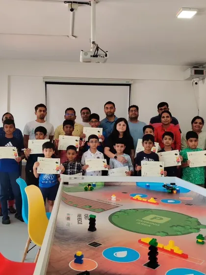 A group photo of our students and their parents during a certificate distribution ceremony. We make sure to formally recognize the completion of our programs and the skills learned.