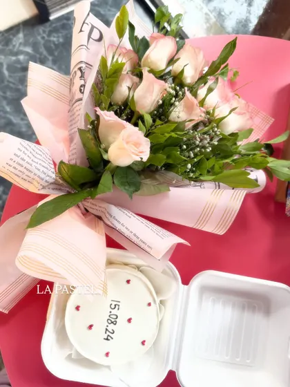 A lovely combo of a simple bento cake with a date and tiny hearts, paired with a beautiful bouquet of pink roses. It's the perfect romantic gift.