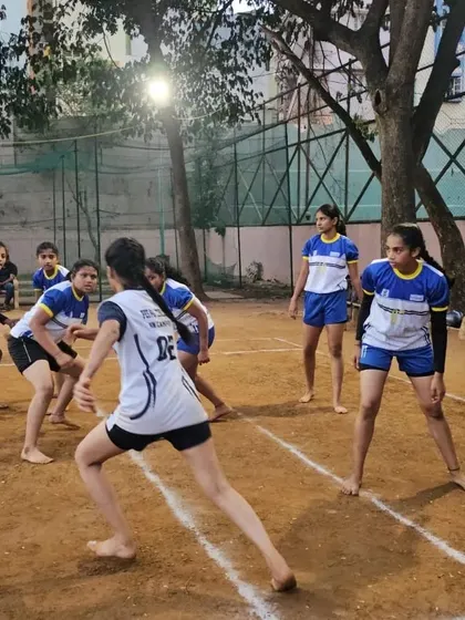 A raider from the opposing team carefully approaches our girls' defensive line during a practice match.