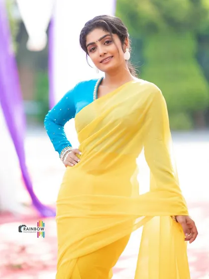 The simple elegance of a chiffon saree paired with a statement blouse. The vibrant colors make this a very cheerful and eye-catching outfit.