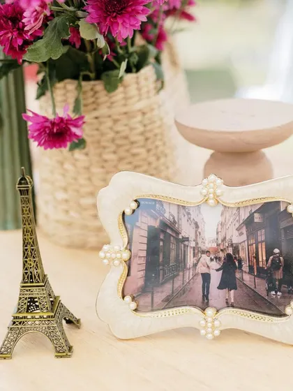 A close-up of a miniature Eiffel Tower prop, used as part of the centerpiece for a Parisian-themed Haldi.