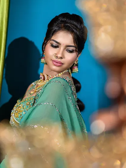 This semi-traditional engagement look combines a modern color palette with classic jewelry. The framing and soft lighting draw attention to the model's expressive features and the detailed outfit.