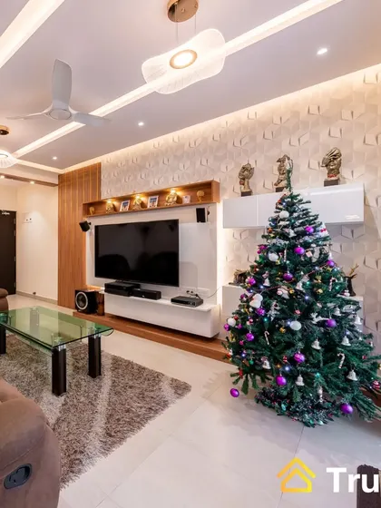 A festive living room ready for Christmas, featuring a contemporary TV unit with a 3D textured wall panel. The space feels both modern and cozy, perfect for holiday celebrations.