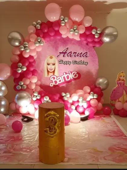 A vibrant Barbie-themed party for a 3rd birthday. This decoration features a custom circular backdrop with the birthday girl's name, multiple shades of pink balloons, Barbie cutouts, and a large foil "3" balloon.