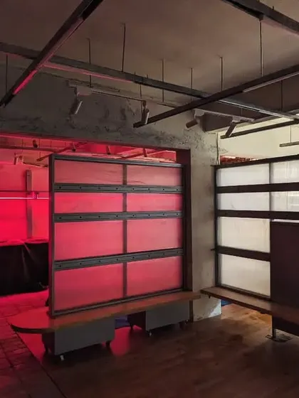 An alternate view of the nearly completed space, showing the interaction between the different lighting zones and the raw, unfinished ceiling.