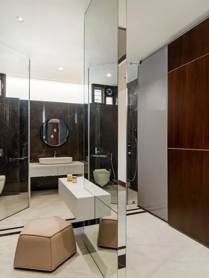 A view of the master bathroom and walk-in closet at Timber Edge, where mirrored surfaces and clean lines create a spacious and modern dressing area.